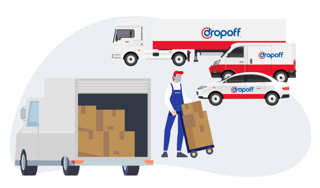 A Dropoff employee unloading a small truck with 3 different Dropoff vehicles in the background.