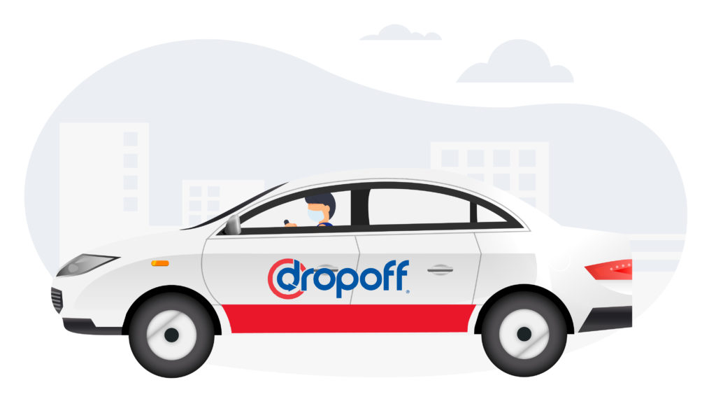 A Dropoff courier driving a Dropoff branding car on a delivery.